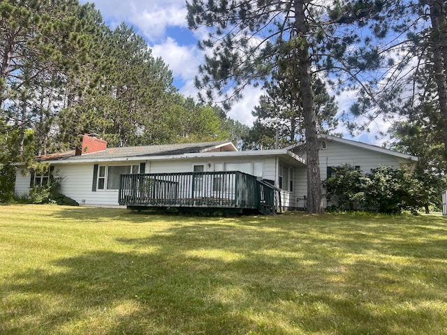 21837 Mishawaka Rd, Grand Rapids, MN 55744 - back of property featuring a wooden deck, a lawn, and a chimney