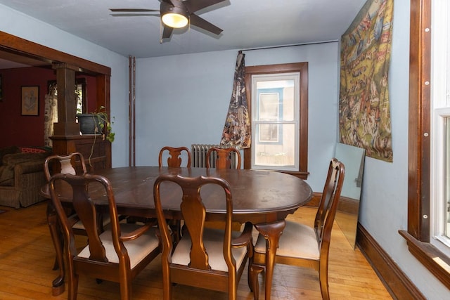 2912 15th Ave S, Minneapolis, MN 55407 - dining room featuring light wood-type flooring, a ceiling fan, ornate columns, and healthy amount of natural light