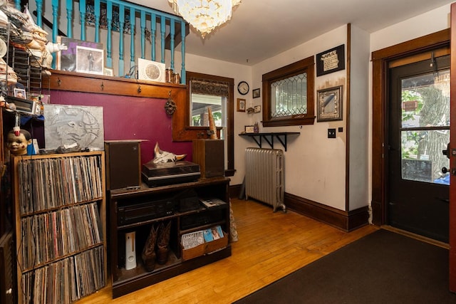 2912 15th Ave S, Minneapolis, MN 55407 - foyer with radiator heating unit, wood-type flooring, and a chandelier