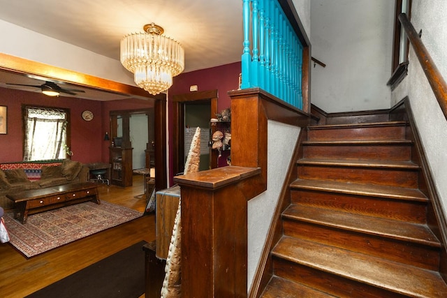 2912 15th Ave S, Minneapolis, MN 55407 - staircase with wood finished floors, ceiling fan, and a chandelier