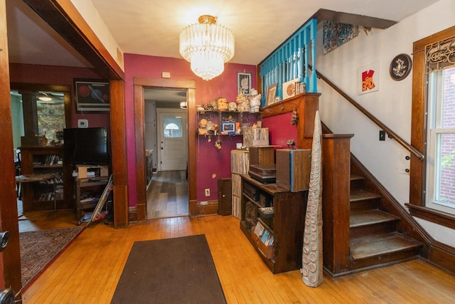2912 15th Ave S, Minneapolis, MN 55407 - entryway featuring hardwood / wood-style flooring, stairway, and a chandelier