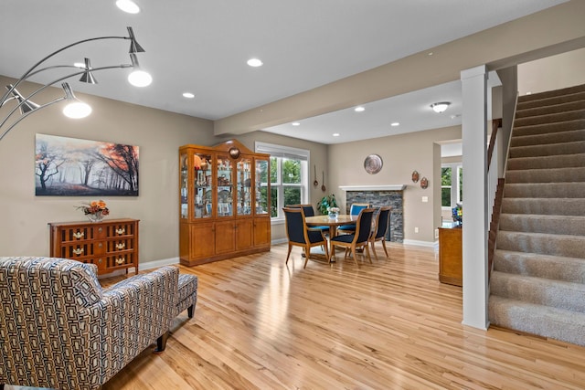 18837 Javelin Way, Lakeville, MN 55044 - living room with stairway, light wood finished floors, a stone fireplace, and recessed lighting