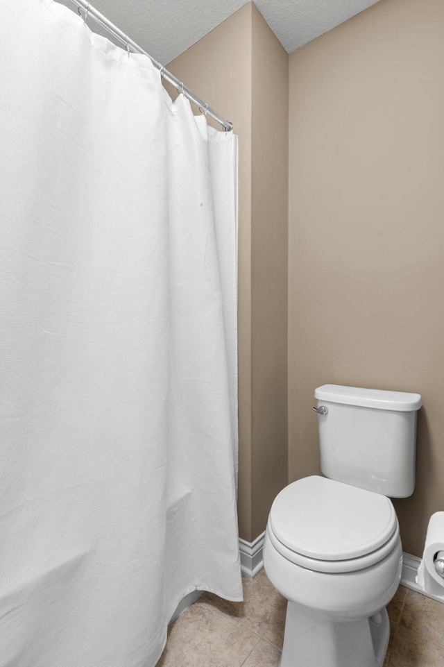 18837 Javelin Way, Lakeville, MN 55044 - full bathroom featuring tile patterned flooring, a textured ceiling, and a shower with shower curtain