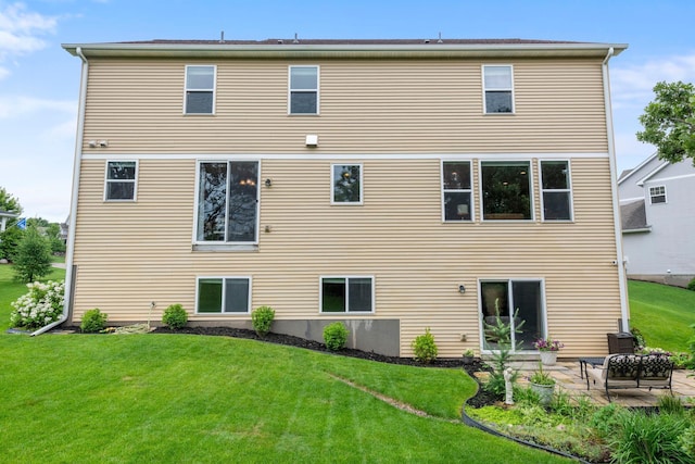 18837 Javelin Way, Lakeville, MN 55044 - rear view of house featuring a yard and a patio area