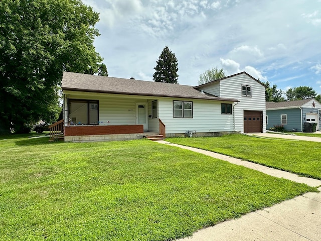 1224 Duba St, Worthington, MN 56187 - view of front facade featuring a porch, driveway, a garage, and a front yard