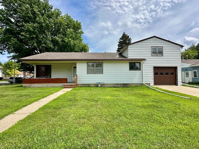 1224 Duba St, Worthington, MN 56187 - view of front facade featuring an attached garage, concrete driveway, a porch, a front yard, and roof with shingles