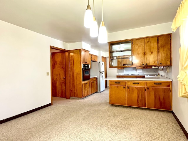 1224 Duba St, Worthington, MN 56187 - kitchen with black oven, freestanding refrigerator, and brown cabinets