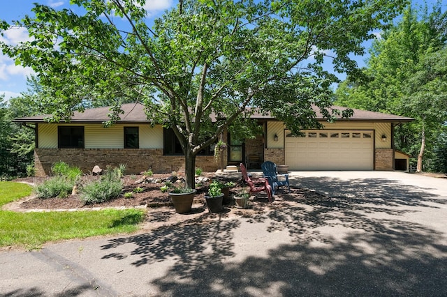 22470 Raven St NW, Oak Grove, MN 55011 - view of front facade with brick siding, driveway, and a garage