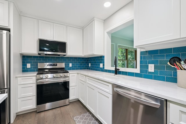 22470 Raven St NW, Oak Grove, MN 55011 - kitchen with stainless steel appliances, light countertops, white cabinets, wood finished floors, and recessed lighting