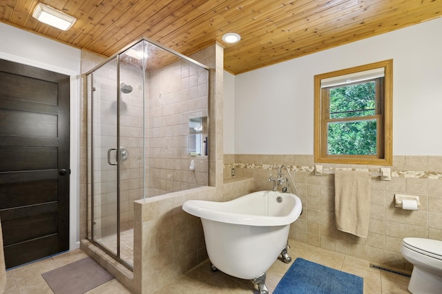 22470 Raven St NW, Oak Grove, MN 55011 - bathroom with tile patterned flooring, wood ceiling, a freestanding bath, a stall shower, and tile walls