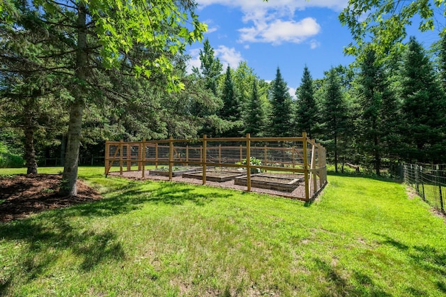 22470 Raven St NW, Oak Grove, MN 55011 - view of yard featuring a vegetable garden and a view of trees