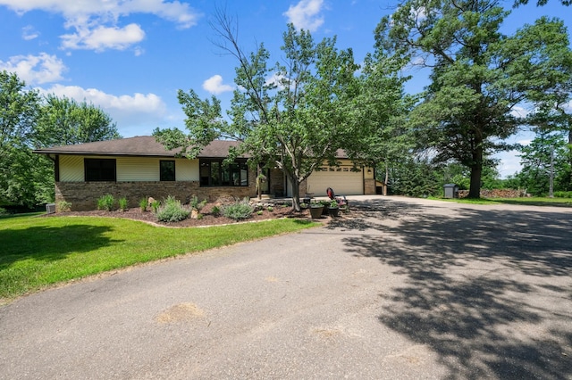 22470 Raven St NW, Oak Grove, MN 55011 - view of front facade featuring driveway, an attached garage, brick siding, and a front yard