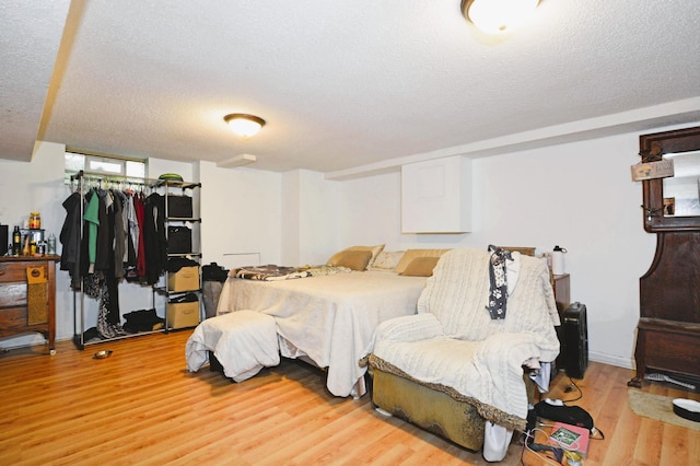 1631 Ross Ave, Saint Paul, MN 55106 - bedroom featuring light wood finished floors, a textured ceiling, and a closet