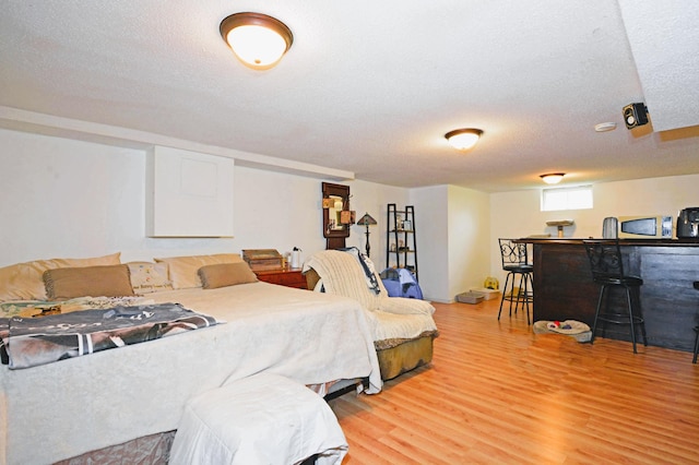 1631 Ross Ave, Saint Paul, MN 55106 - bedroom with a dry bar, light wood-style floors, and a textured ceiling