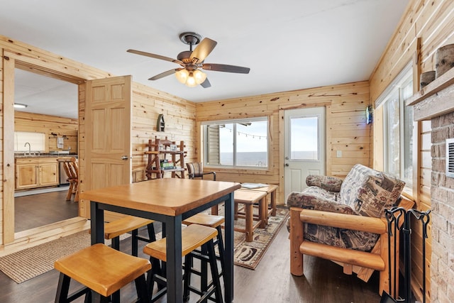 46317 Lucretia Ln, Isle, MN 56342 - dining space with wooden walls, dark wood-type flooring, and ceiling fan