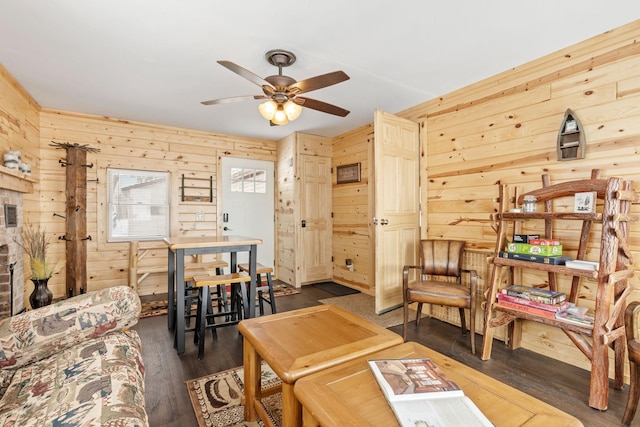 46317 Lucretia Ln, Isle, MN 56342 - living area with wooden walls, ceiling fan, and dark wood finished floors