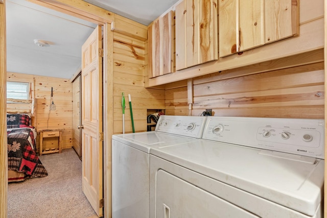 46317 Lucretia Ln, Isle, MN 56342 - laundry area featuring wood walls, light carpet, separate washer and dryer, and cabinet space