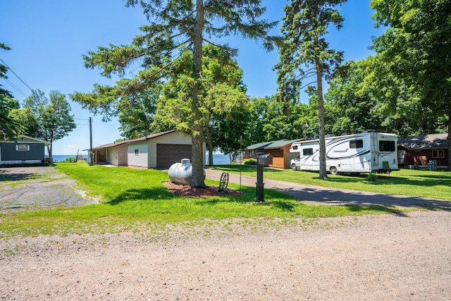 46317 Lucretia Ln, Isle, MN 56342 - view of front facade with a front lawn and a garage