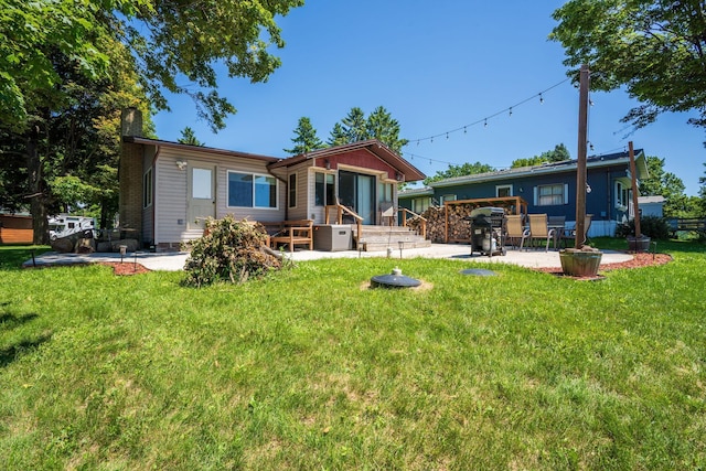 46317 Lucretia Ln, Isle, MN 56342 - rear view of property featuring a chimney, a patio area, and a yard