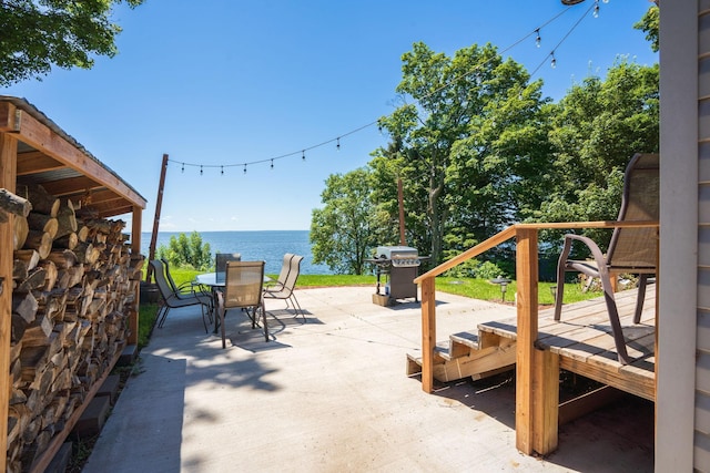 46317 Lucretia Ln, Isle, MN 56342 - view of patio / terrace with outdoor dining area, grilling area, and a water view