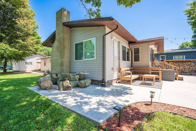46317 Lucretia Ln, Isle, MN 56342 - back of house with a patio area, a chimney, and a yard