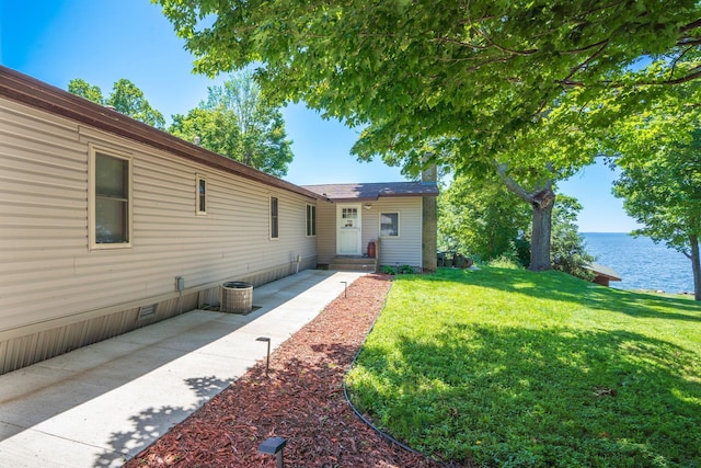 46317 Lucretia Ln, Isle, MN 56342 - view of front facade featuring a front lawn, a water view, and a patio