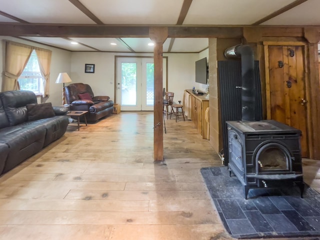 5566 Little Marais Rd, Crystal Bay Twp, MN 55603 - living area with a wood stove, healthy amount of natural light, beam ceiling, light wood-style flooring, and recessed lighting