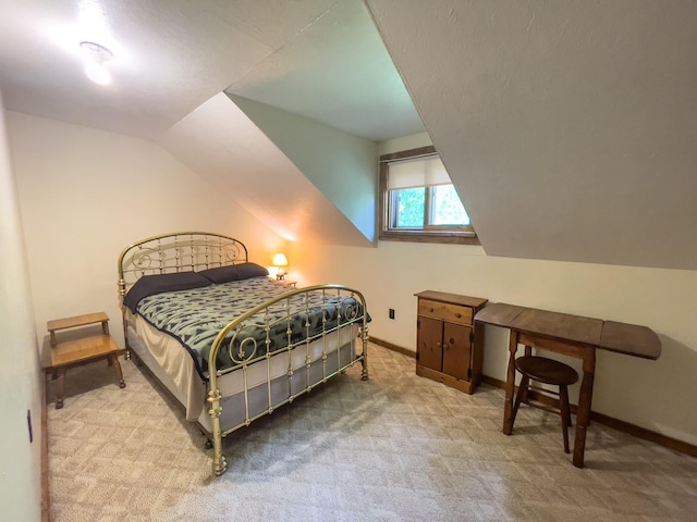 5566 Little Marais Rd, Crystal Bay Twp, MN 55603 - bedroom with vaulted ceiling and carpet flooring