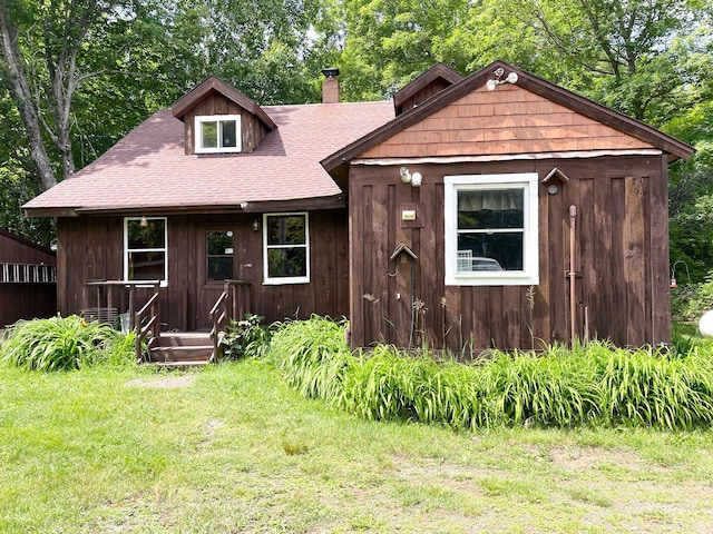 5566 Little Marais Rd, Crystal Bay Twp, MN 55603 - chalet / cabin featuring a chimney, roof with shingles, and a front yard