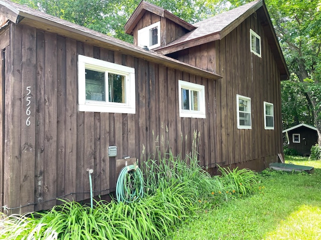 5566 Little Marais Rd, Crystal Bay Twp, MN 55603 - view of side of property featuring a storage unit and board and batten siding