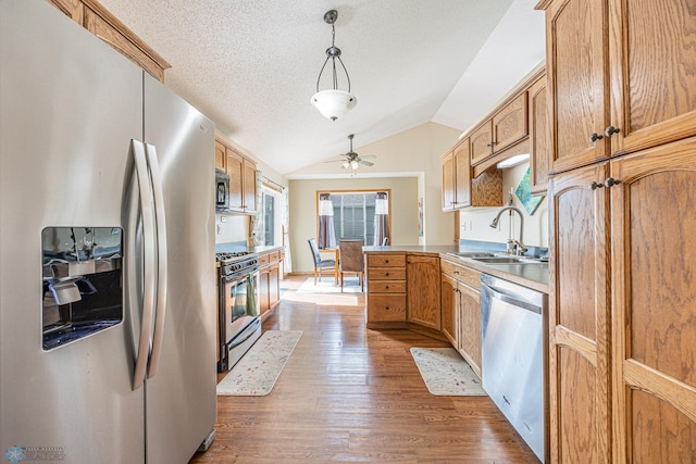 3730 Taylor St S, Fargo, ND 58104 - kitchen with appliances with stainless steel finishes, ceiling fan, dark wood-type flooring, lofted ceiling, and a textured ceiling