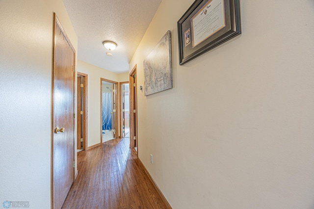 3730 Taylor St S, Fargo, ND 58104 - corridor with wood finished floors and a textured ceiling