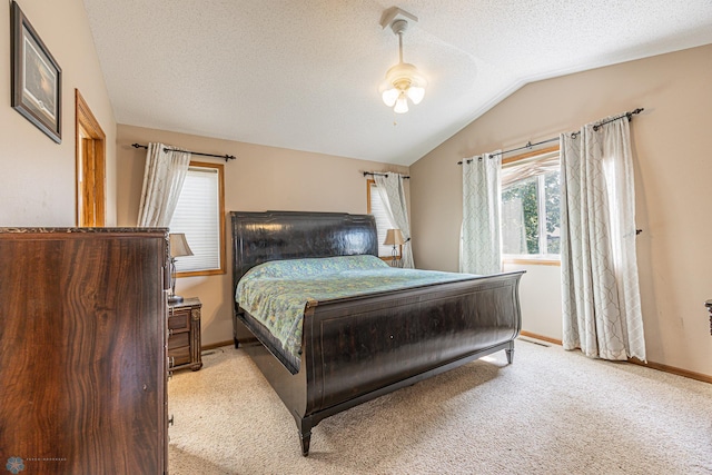 3730 Taylor St S, Fargo, ND 58104 - bedroom featuring multiple windows, light colored carpet, vaulted ceiling, a ceiling fan, and a textured ceiling