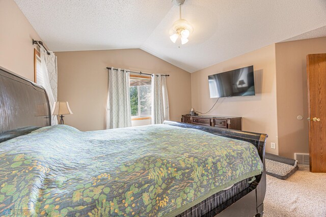 3730 Taylor St S, Fargo, ND 58104 - carpeted bedroom with lofted ceiling, ceiling fan, and a textured ceiling