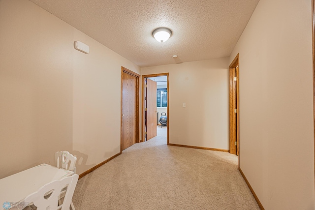 3730 Taylor St S, Fargo, ND 58104 - hallway featuring a textured ceiling and light colored carpet