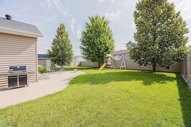 3730 Taylor St S, Fargo, ND 58104 - fenced backyard with a playground and a patio