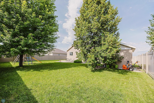 3730 Taylor St S, Fargo, ND 58104 - fenced backyard with a patio and a playground
