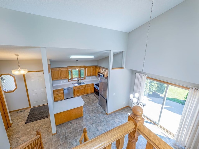 133 Summerfield Ct, Waverly, MN 55390 - kitchen with appliances with stainless steel finishes, light countertops, brown cabinets, and decorative light fixtures