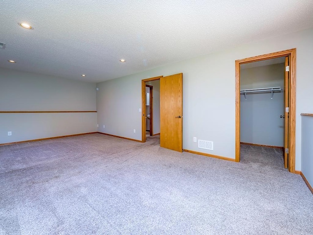 133 Summerfield Ct, Waverly, MN 55390 - unfurnished bedroom featuring recessed lighting, carpet floors, a spacious closet, and a textured ceiling