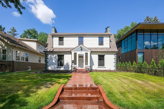 2440 37th Ave S, Minneapolis, MN 55406 - colonial inspired home featuring a chimney, brick siding, and a shingled roof