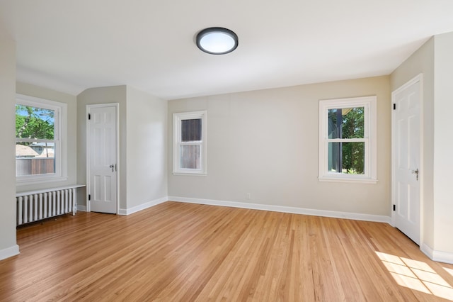 2440 37th Ave S, Minneapolis, MN 55406 - unfurnished room with radiator and light wood-style floors