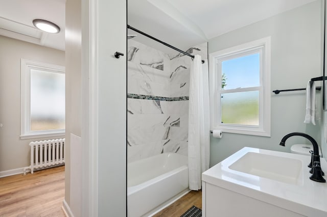 2440 37th Ave S, Minneapolis, MN 55406 - bathroom featuring radiator, shower / bath combo, wood finished floors, and vanity