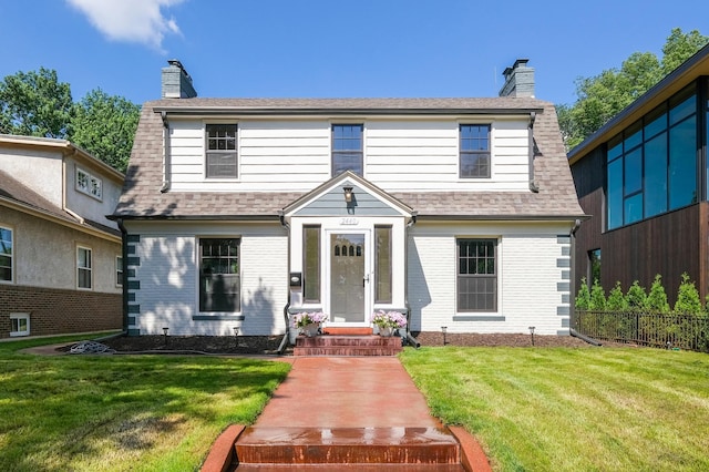 2440 37th Ave S, Minneapolis, MN 55406 - view of front of home featuring a chimney, brick siding, and roof with shingles