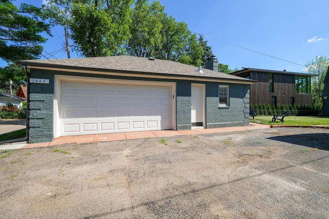 2440 37th Ave S, Minneapolis, MN 55406 - view of front facade featuring brick siding, a detached garage, a chimney, and an outdoor structure