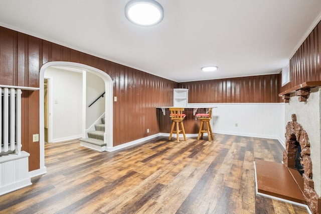 2440 37th Ave S, Minneapolis, MN 55406 - indoor dry bar with arched walkways, wood finished floors, stairway, and wood walls