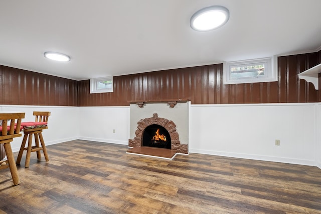 2440 37th Ave S, Minneapolis, MN 55406 - unfurnished living room featuring wood finished floors, a brick fireplace, and wood walls
