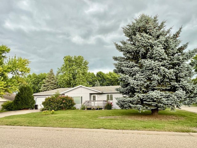 1002 6th Ave N, Wheaton, MN 56296 - view of front of property with driveway, a front yard, an attached garage, and a wooden deck
