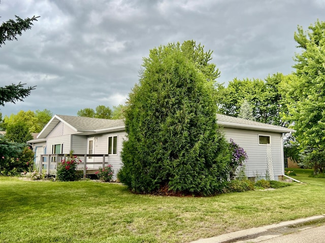1002 6th Ave N, Wheaton, MN 56296 - view of side of property with a lawn, a chimney, and a wooden deck