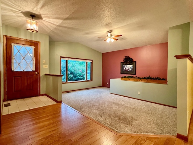 1002 6th Ave N, Wheaton, MN 56296 - foyer with vaulted ceiling, wood finished floors, ceiling fan, a textured ceiling, and a chandelier