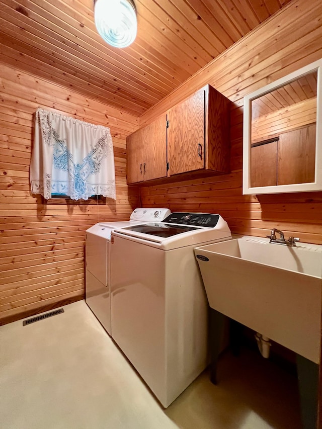 1002 6th Ave N, Wheaton, MN 56296 - laundry room featuring separate washer and dryer, wooden walls, cabinet space, and wooden ceiling